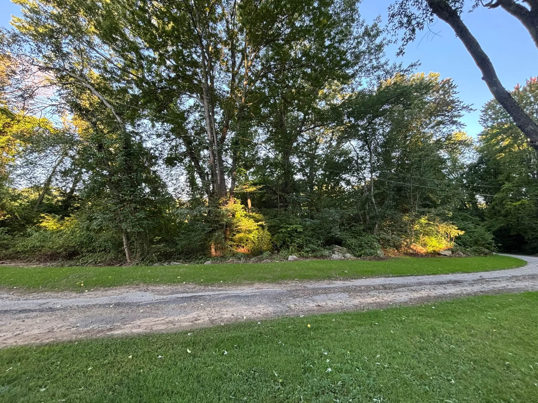 After — regraded slope with loam and established grass, Spencer MA
